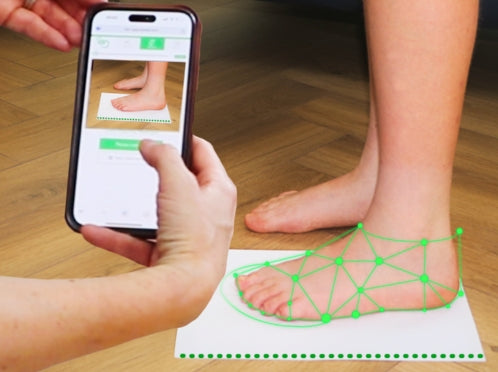 Parent using smartphone to scan child’s foot for accurate shoe sizing with Dubs smart fit tool