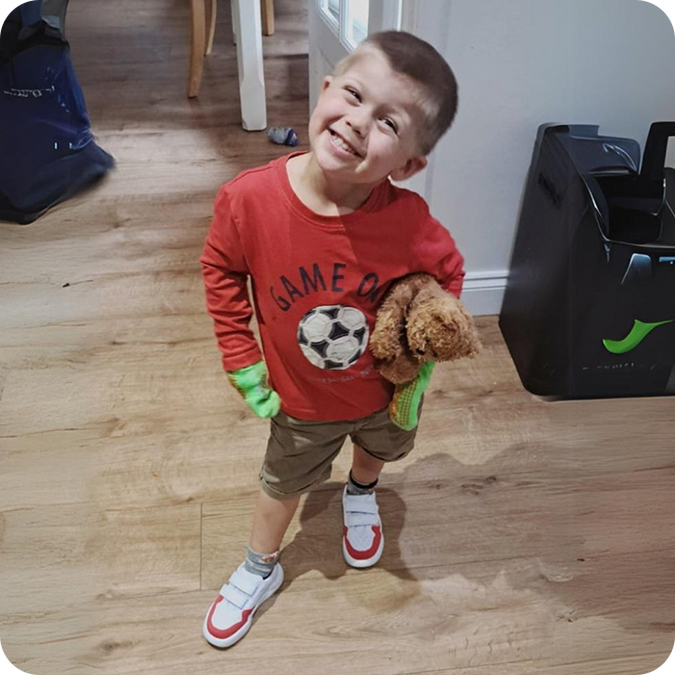 Boy wearing Dubs Glide comfortable  lightweight kids' trainers in red