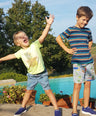 children wearing machine washable blue trainers on summer holidays
