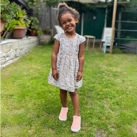 Pink Dubs Flex wide-fit sensory-friendly kids trainer, girl in garden