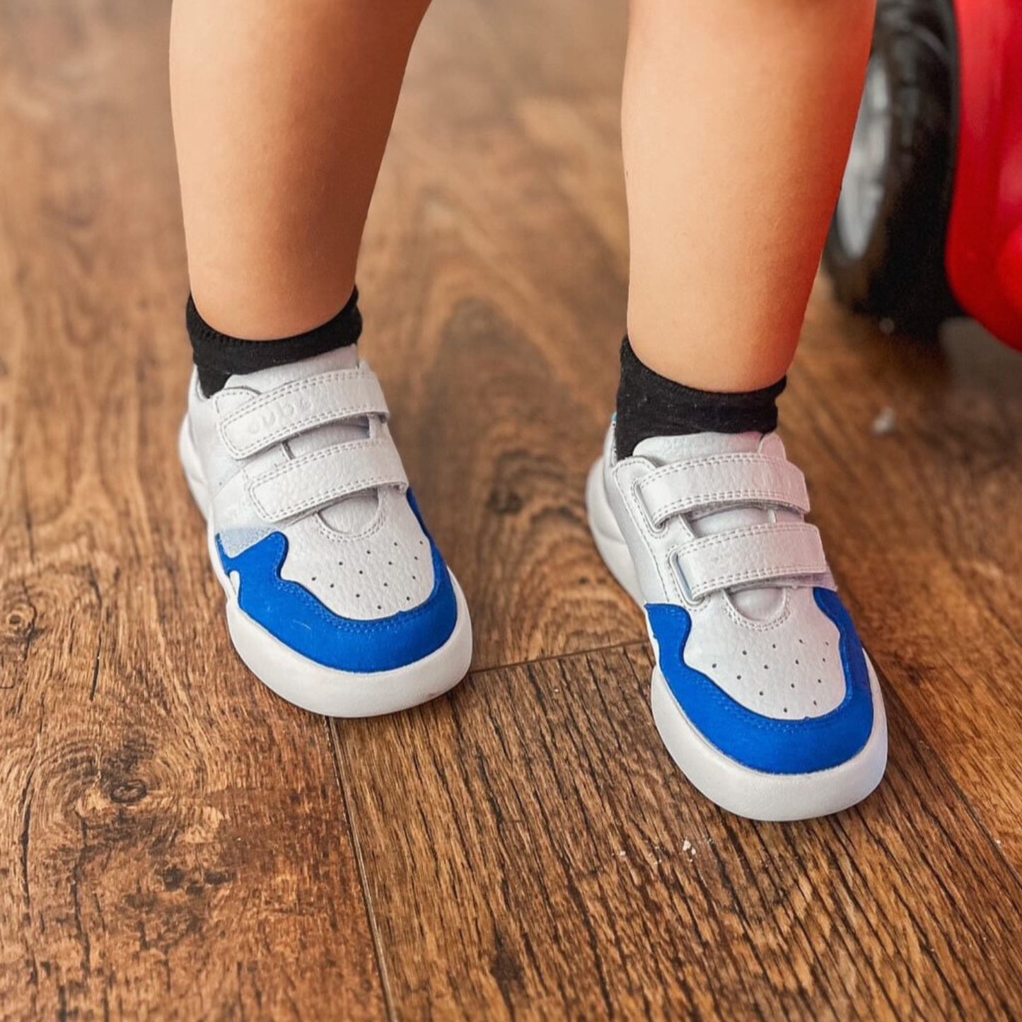 Blue and white Dubs glide wide-fit quality durable leather kids trainer, close up view