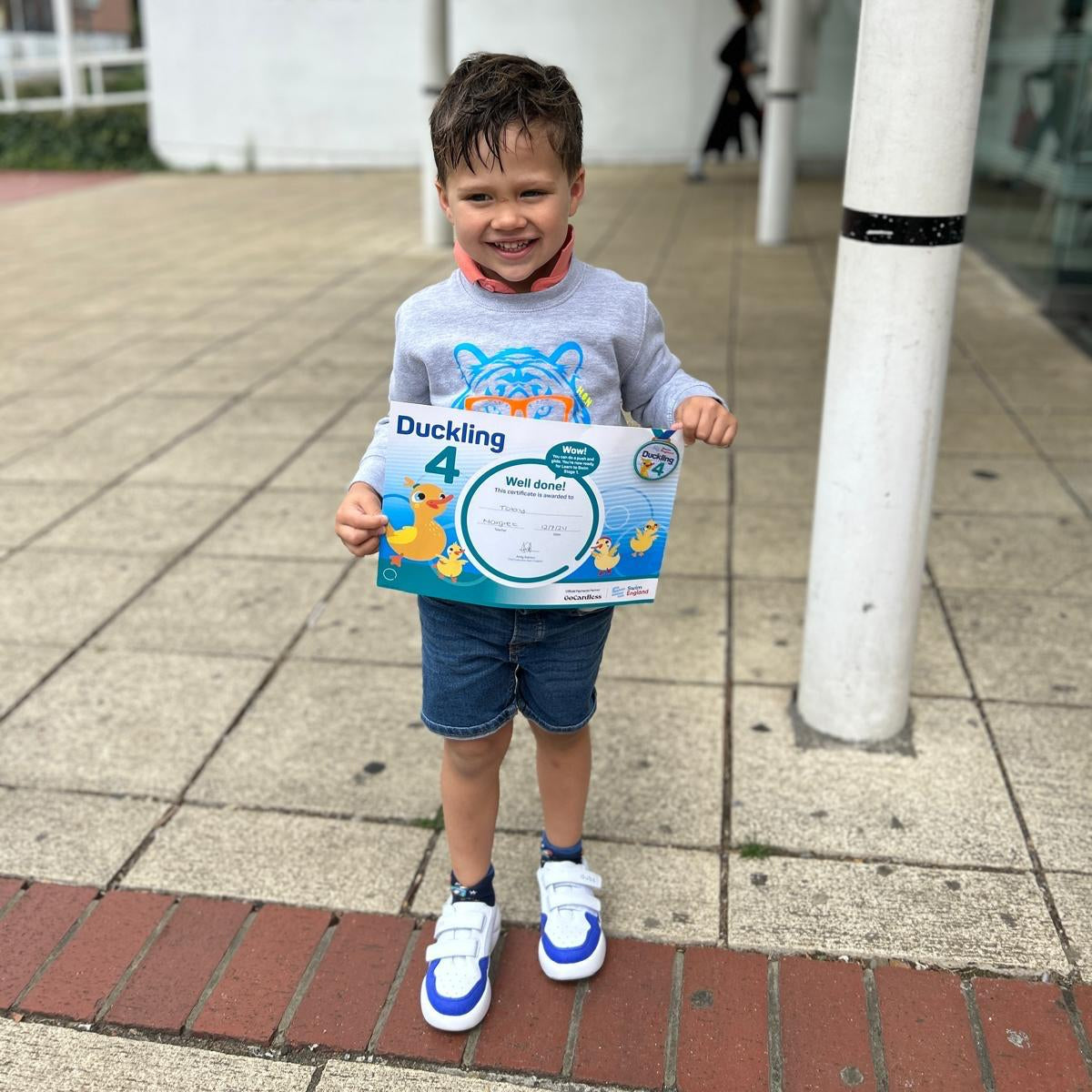 Blue and white Dubs glide wide-fit quality durable leather kids trainer, boy with swimming award