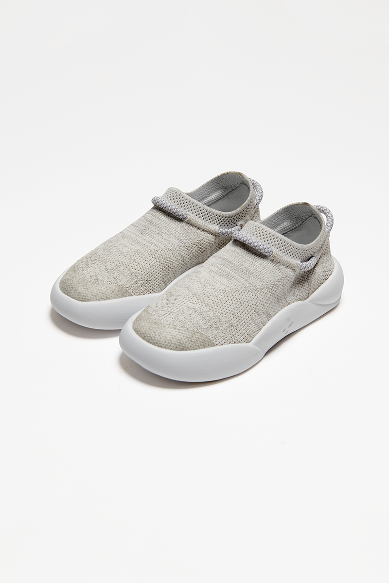 pair of grey childrens trainers made from recycled plastic sugar cane sole